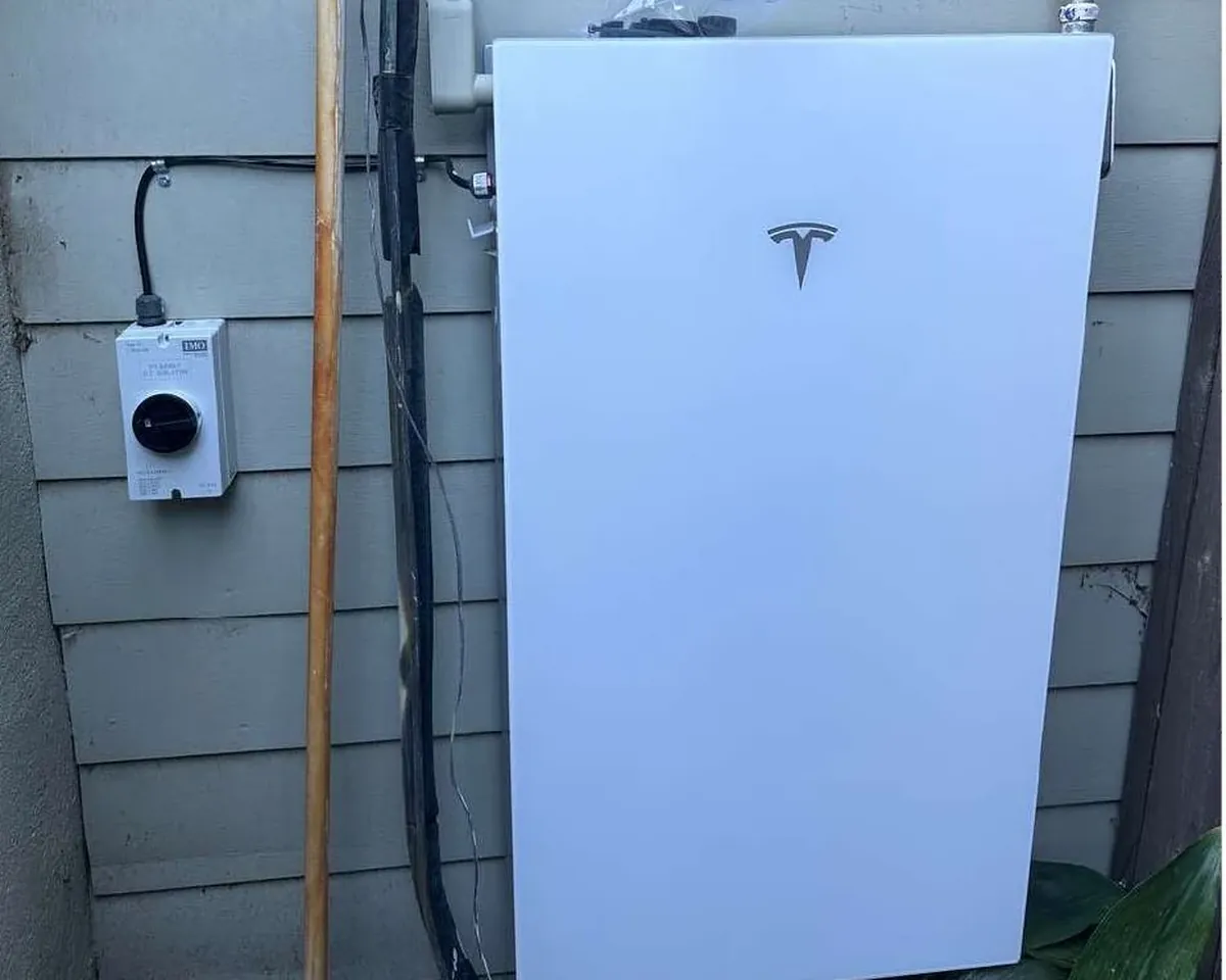Home solar battery storage unit mounted on a garage wall