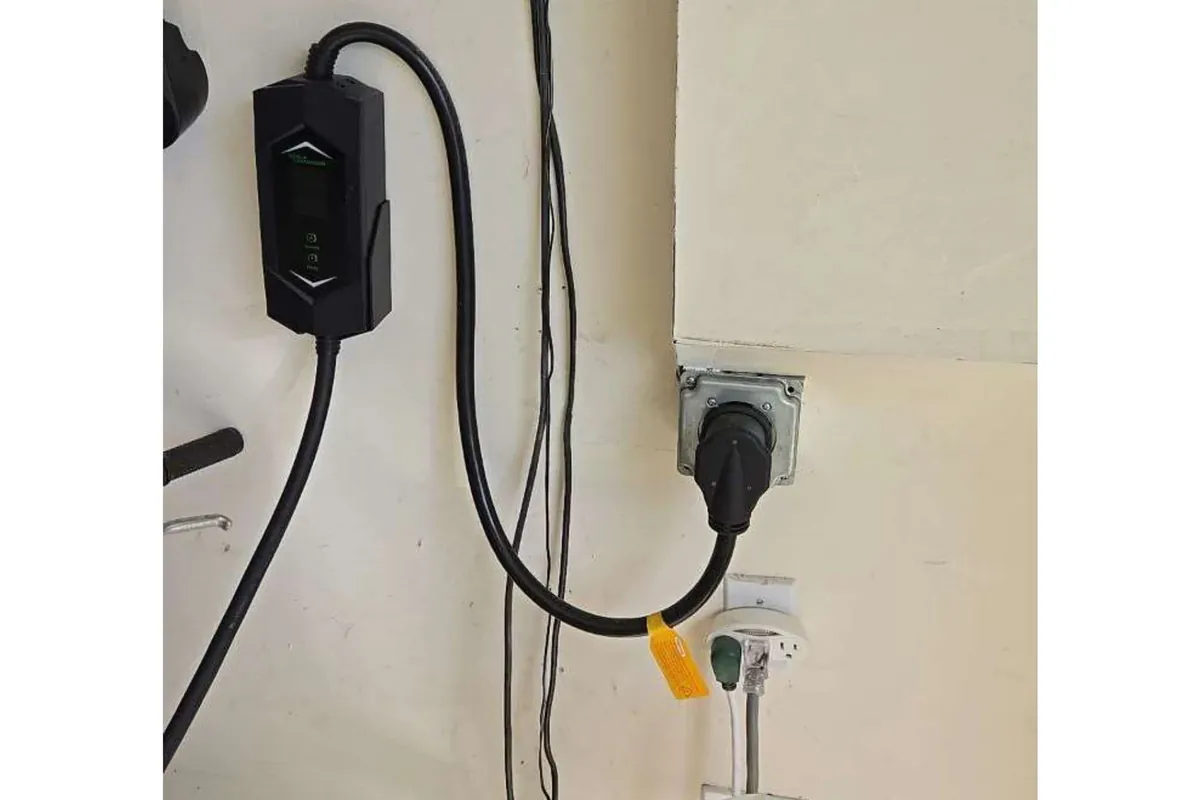 Wall-mounted home EV charger connected to an electric vehicle