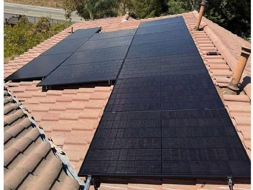All-black solar panels on a clay tile roof