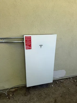 Tesla Powerwall 3 installed on an outside wall