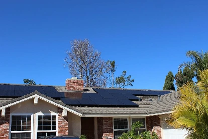 Rooftop solar installation on a single-story home with a brick chimney