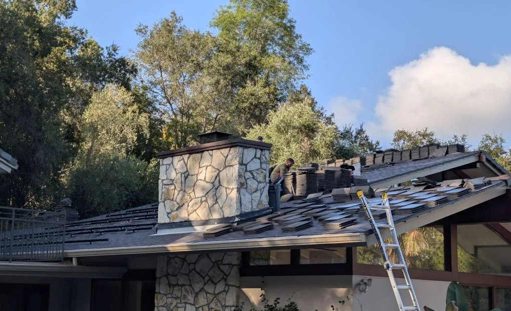 During: the team removing the old concrete tile after taking the solar panels off